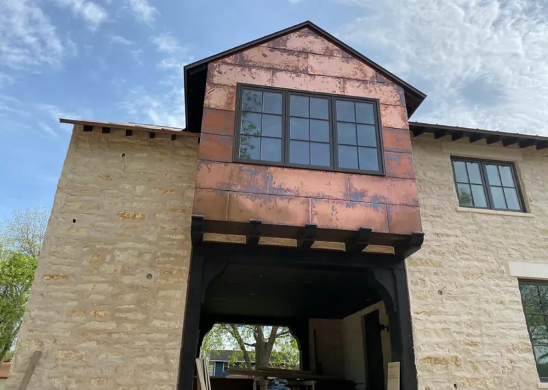Copper metal panel facade on a stone building for Metal Roof Coating in Camp Swift