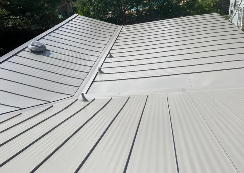 Solar attic fan installed on a metal roof for Roof Ventilation in Camp Swift